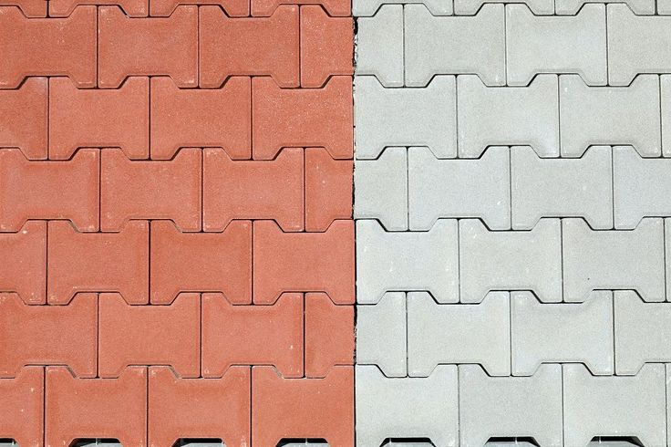 Red and gray interlocking concrete paver blocks. Tiles for outdoor .