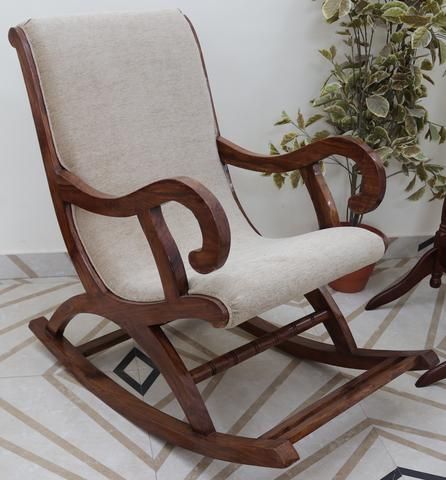 A gorgeous wooden rocking chair with exquisite detailing and .