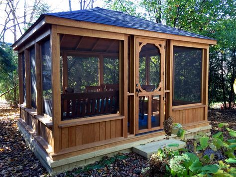 This gazebo features a low knee wall and large screened walls .