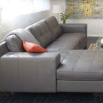 Montez sectional in gray leather, topstiched seat and back .