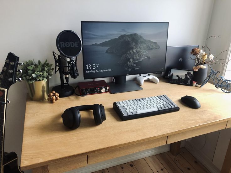 Vertical laptop stand with USB-C monitor and wireless peripherals .