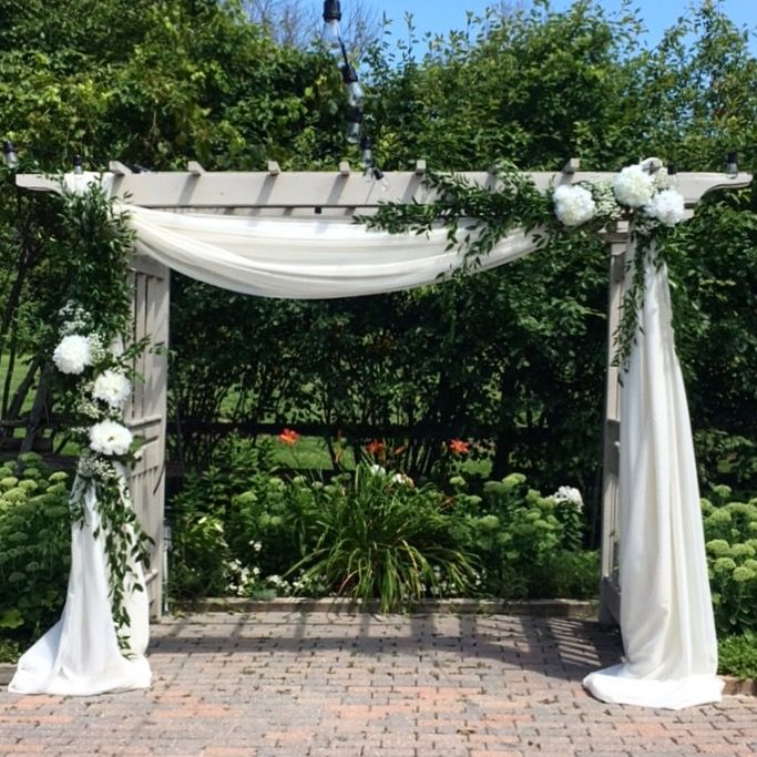 White fabric and greenery on a wooden wedding Arbor | Wedding .